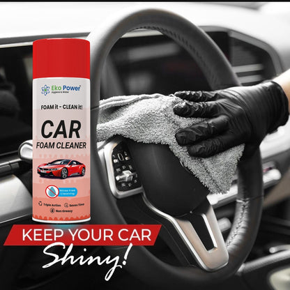 Car foam cleaner spray with a gloved hand cleaning a car interior.